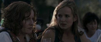 Movie still from “The Square” (2008), directed by Nash Edgerton – Two women sitting next to each other at a party; Close Up shot, Over the shoulder angle