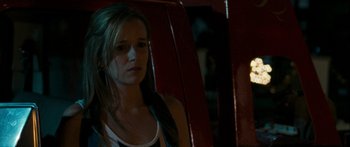 Movie still from “The Square” (2008), directed by Nash Edgerton – A woman sitting in a chair in a dark room; Close Up shot, High angle