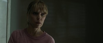 Movie still from “The Square” (2008), directed by Nash Edgerton – A woman in a pink shirt is looking at the camera; Close Up shot, Low angle
