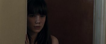 Movie still from “The Square” (2008), directed by Nash Edgerton – A woman with long black hair and bangs looking at the camera; Close Up shot, Over the shoulder angle