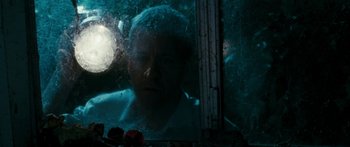 Movie still from “The Square” (2008), directed by Nash Edgerton – A man looking out of a window at night; Close Up shot, Low angle