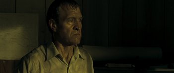 Movie still from “The Square” (2008), directed by Nash Edgerton – A person wearing a white shirt; Close Up shot, Low angle