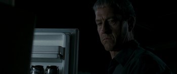 Movie still from “The Square” (2008), directed by Nash Edgerton – A man standing in front of an open refrigerator; Close Up shot, Over the shoulder angle