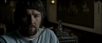 Movie still from “The Square” (2008), directed by Nash Edgerton – A person sitting in a room; Close Up shot, Over the shoulder angle