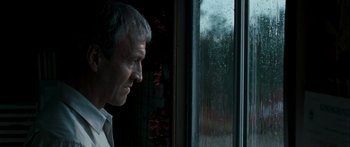 Movie still from “The Square” (2008), directed by Nash Edgerton – A person looking out of a window; Close Up shot, Over the shoulder angle