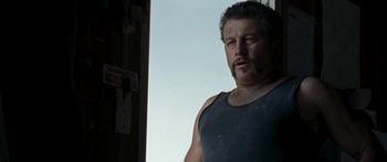 Movie still from “The Square” (2008), directed by Nash Edgerton – A person wearing a tank top; Close Up shot, Low angle