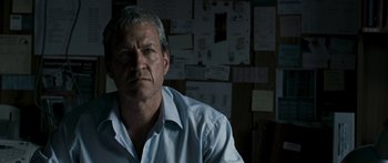 Movie still from “The Square” (2008), directed by Nash Edgerton – A person wearing a blue shirt; Close Up shot, Low angle