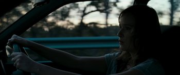 Movie still from “The Square” (2008), directed by Nash Edgerton – A woman sitting in the driver's seat of a car; Close Up shot, Over the shoulder angle