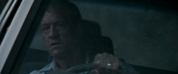 Movie still from “The Square” (2008), directed by Nash Edgerton – A man sitting in the driver's seat of a car; Close Up shot, Over the shoulder angle