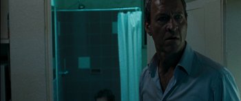 Movie still from “The Square” (2008), directed by Nash Edgerton – A man standing in front of a bathroom mirror; Close Up shot, Over the shoulder angle