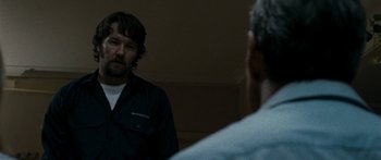 Movie still from “The Square” (2008), directed by Nash Edgerton – A man standing in front of a mirror in front of another man; Close Up shot, Over the shoulder angle