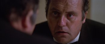 Movie still from “The Star Chamber” (1983), directed by Peter Hyams – A person wearing a suit and tie; Close Up shot, Low angle