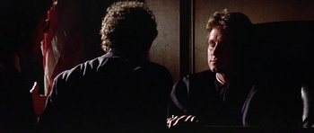Movie still from “The Star Chamber” (1983), directed by Peter Hyams – A man is looking at himself in the mirror; Close Up shot, Over the shoulder angle