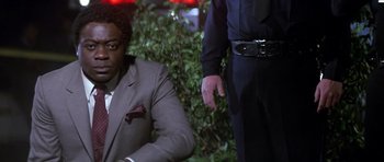 Movie still from “The Star Chamber” (1983), directed by Peter Hyams – A man in a suit and tie sitting next to a man in a police uniform; Close Up shot, Low angle