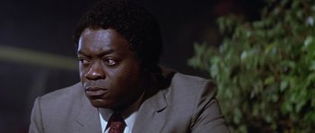 Movie still from “The Star Chamber” (1983), directed by Peter Hyams – A person wearing a suit and tie; Close Up shot, Over the shoulder angle