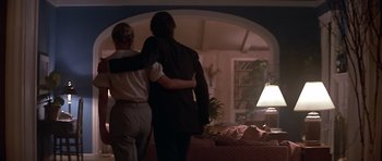 Movie still from “The Star Chamber” (1983), directed by Peter Hyams – A man and a woman standing in front of a couch; Wide shot, Low angle