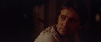 Movie still from “The Star Chamber” (1983), directed by Peter Hyams – A person sitting down with his eyes closed; Close Up shot, Over the shoulder angle