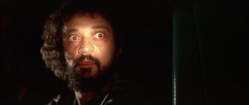 Movie still from “The Star Chamber” (1983), directed by Peter Hyams – A person with a beard smoking a pipe; Close Up shot, Low angle