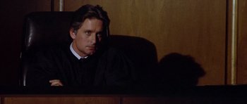 Movie still from “The Star Chamber” (1983), directed by Peter Hyams – A man sitting in front of a judge's chair; Close Up shot, Low angle