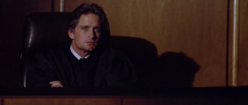 Movie still from “The Star Chamber” (1983), directed by Peter Hyams – A man sitting in front of a judge's chair; Close Up shot, Low angle