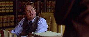 Movie still from “The Star Chamber” (1983), directed by Peter Hyams – A man sitting in front of a table with papers on top of it; Close Up shot, Over the shoulder angle