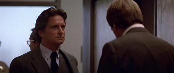 Movie still from “The Star Chamber” (1983), directed by Peter Hyams – A man wearing a suit and tie talking to another man wearing a suit and tie; Close Up shot, Over the shoulder angle