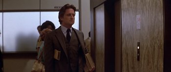 Movie still from “The Star Chamber” (1983), directed by Peter Hyams – A man in a suit and tie; Medium shot, Low angle