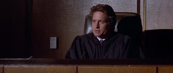 Movie still from “The Star Chamber” (1983), directed by Peter Hyams – A judge sitting in front of a judge's chair; Close Up shot, Low angle