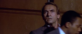 Movie still from “The Star Chamber” (1983), directed by Peter Hyams – A person wearing a suit and tie; Close Up shot, Over the shoulder angle