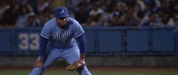 Movie still from “The Star Chamber” (1983), directed by Peter Hyams – A baseball player in a blue uniform is ready to catch a ball; Medium shot, High angle