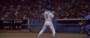 Movie still from “The Star Chamber” (1983), directed by Peter Hyams – A baseball player holding a baseball bat on top of a baseball field; Wide shot, Low angle