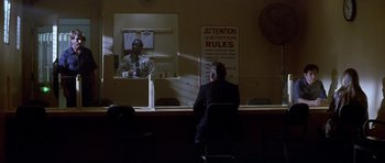 Movie still from “The Star Chamber” (1983), directed by Peter Hyams – A man sitting in front of a mirror in a room; Wide shot, Over the shoulder angle