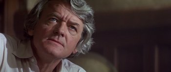 Movie still from “The Star Chamber” (1983), directed by Peter Hyams – An older man with grey hair looking up; Close Up shot, Low angle
