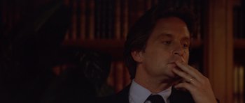 Movie still from “The Star Chamber” (1983), directed by Peter Hyams – A person wearing a suit and tie; Close Up shot, Low angle