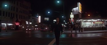 Movie still from “The Star Chamber” (1983), directed by Peter Hyams – A man walking across a street at night; Wide shot, Low angle