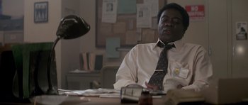 Movie still from “The Star Chamber” (1983), directed by Peter Hyams – A man sitting at a table in front of papers; Medium shot, Low angle