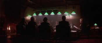 Movie still from “The Star Chamber” (1983), directed by Peter Hyams – A group of people sitting at a table in front of a projection screen; Wide shot, Over the shoulder angle