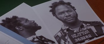 Movie still from “The Star Chamber” (1983), directed by Peter Hyams – A man's face in an old photo; Extreme Close Up shot, Overhead angle