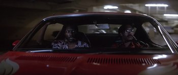 Movie still from “The Star Chamber” (1983), directed by Peter Hyams – Two people in a red car looking out the window at night; Medium shot, Low angle