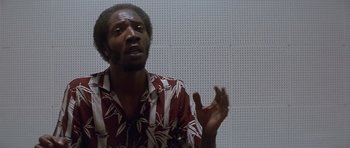 Movie still from “The Star Chamber” (1983), directed by Peter Hyams – A man in a red and white shirt is talking; Close Up shot, Low angle