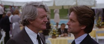 Movie still from “The Star Chamber” (1983), directed by Peter Hyams – Two men in business suits talking to each other; Close Up shot, Over the shoulder angle