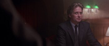 Movie still from “The Star Chamber” (1983), directed by Peter Hyams – A man wearing a suit and tie sitting in a room; Close Up shot, Over the shoulder angle