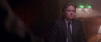 Movie still from “The Star Chamber” (1983), directed by Peter Hyams – A man wearing a suit and tie sitting in a chair; Close Up shot, Low angle