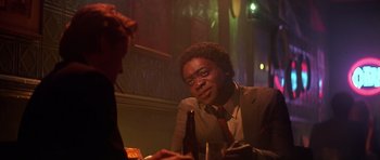 Movie still from “The Star Chamber” (1983), directed by Peter Hyams – A man sitting at a table with a woman; Close Up shot, Over the shoulder angle