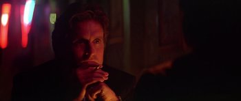 Movie still from “The Star Chamber” (1983), directed by Peter Hyams – A man sitting in a dark room with his hand on his chin; Close Up shot, Low angle