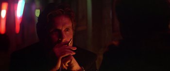 Movie still from “The Star Chamber” (1983), directed by Peter Hyams – A man smoking a cigarette in a dark room; Close Up shot, Over the shoulder angle