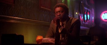 Movie still from “The Star Chamber” (1983), directed by Peter Hyams – A man sitting at a table with a glass of wine; Close Up shot, Low angle