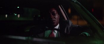 Movie still from “The Star Chamber” (1983), directed by Peter Hyams – A man sitting in the back seat of a car at night; Close Up shot, Low angle