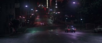 Movie still from “The Star Chamber” (1983), directed by Peter Hyams – A car driving down a street at night; Extreme Wide shot, Low angle