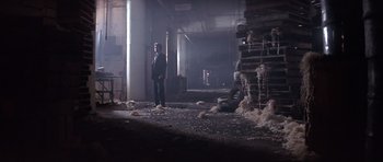 Movie still from “The Star Chamber” (1983), directed by Peter Hyams – A man standing in an industrial setting near a pile of trash; Wide shot, Low angle